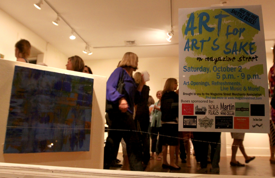 Attendees gather to look at artwork at Cole Pratt Gallery.