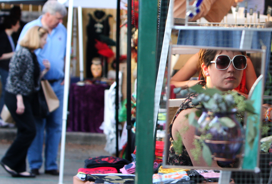 Jewelry maker Anna Quinn looks in to a Paraph mirror by Caitlin Waugh at a Freret Market event in 2010. (UptownMessenger.com file photo by Sabree Hill)