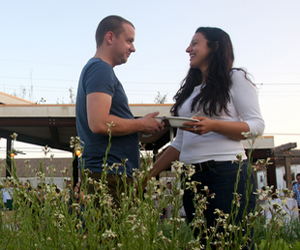 Natalie Praetorius and Travis Brannen stand behind and arugula plant at Edible Schoolyard NOLA-An Edible Evening 2010 at the Samuel J. Green Charter School. Proceeds from the event go directly towards program support to ensure the sustainability of the Edible Schoolyard NOLAâs garden and kitchen programs. "We came here to see the garden and to eat," said Praetorius. (Sabree Hill, UptownMessenger.com)