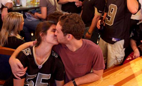 SaintsTraceys2012 00008 A couple kisses at a commercial break during the Saints season opener. (Sabree Hill, UptownMessenger.com)