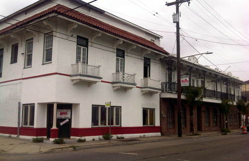 The corner of Freret and Cadiz, showing the row of large commercial buildings owned by the Barreca family. The brick buildings to the right are slated for demolition; the white building on the left will be preserved. (UptownMessenger.com file photo dated March 21, 2012)