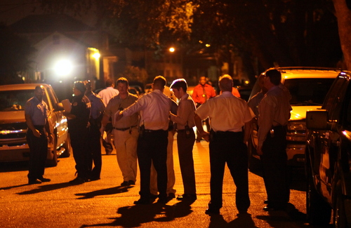 Police officers and detectives fill South Saratoga Street as they investigate the fatal shooting of a 1-year-old girl Thursday night. (Robert Morris, UptownMessenger.com)