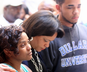 City Councilwoman LaToya Cantrell (center) grasps hands with Andrea Samuels and Keion Reed on Sept. 1, the day after their 1-year-old baby was killed in Central City gunfire. (UptownMessenger.com file photo by Robert Morris)