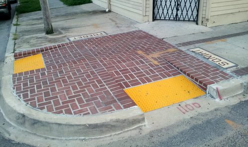 The brick "bumpout" corners installed last year on Freret Street are all scheduled to be replaced this fall, officials said. (Robert Morris, UptownMessenger.com)