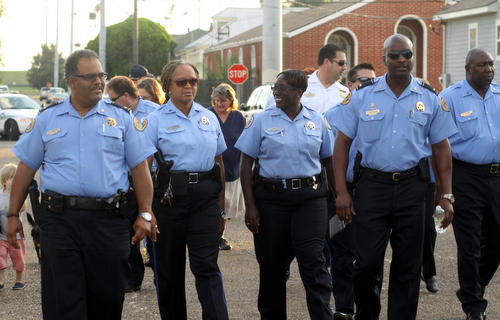 The NOPD Second District holds its monthly anti-crime march through west Carrollton on Wednesday evening. The Uptown-based district has one of the lowest numbers of officers in the city. (Sabree Hill, UptownMessenger.com)
