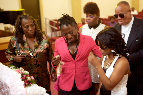 Andrea Samuels (far right), mother of Londyn Samuels, cries as she looks at her daughter in her casket at the funeral Saturday morning. "She was extraordinary," said Samuels about her daughter. (Sabree Hill, UptownMessenger.com)