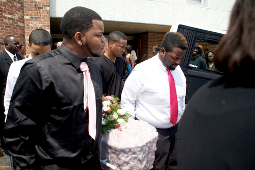 The casket of Londyn Samuels, 1, is carried out of New Hope Baptist Church and placed in a hearse after the funeral. (Sabree Hill, UptownMessenger.com)