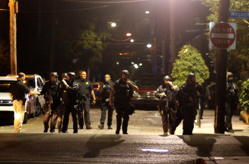 The NOPD SWAT Team marches onto Magazine Street after searching Pleasant Street for a robbery suspect. (Robert Morris, UptownMessenger.com)
