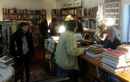 Maggie McKeown (right) talks to musician George Alvey Jr. on Thursday, the day after she announced that McKeown's Books and Difficult Music will close at the end of the month. (Robert Morris, UptownMessenger.com)