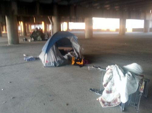 The blue tent where people staying under the Pontchartrain Expressway said a woman was found dead Wednesday afternoon. (Robert Morris, UptownMessenger.com)