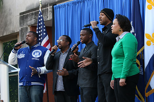 City Councilwoman LaToya Cantrell and a group from Franklin Avenue Baptist Church sing "We Shall Overcome" in front of City Hall before the 27th annual MLK Jr. Day parade.