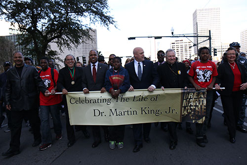 U.S. Attorney Kenneth Polite (middle left), Mayor Mitch Landrieu (middle right), Archbishop Gregory Aymond (far right) and others lead the 27th annual MLK Jr. Day parade down Poydras Ave.