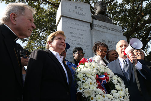 New Orleans mayor Mitch Landrieu (far right) gives his final remarks alongside Archbishop Gregory Aymond (left) and City Councilwoman Susan Guidry (middle) after a wreath was brought to the MLK Memorial on Claiborne Ave. (Zach Brien, UptownMessenger.com)