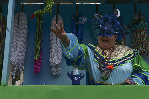 Rider throws beads from the "Catchin' Crabs on Bourbon Street" float. Krewe of King Arthur 2014.