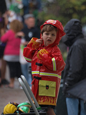 Aspiring firefighter puts aside his ambitions to catch some beads. Krewe of Carrolton 2014. (Zach Brien, UptownMessenger.com)