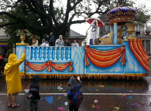 The queen of the Krewe of Alla holds an umbrella as her float rolls on Magazine Street in the rain. (Robert Morris, UptownMessenger.com)