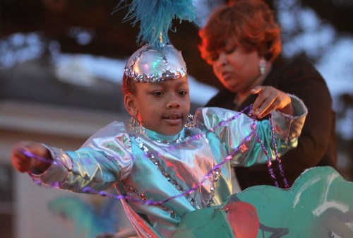 A young rider in the Krewe of Oshun's "Yemoja and Emperor" float. (Robert Morris, UptownMessenger.com)