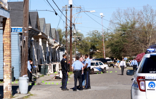 Police officers surround the intersection of Foucher and South Saratoga Streets, where there people were injured in a shooting Thursday afternoon. (Robert Morris, UptownMessenger.com)