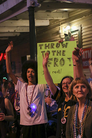 Parade goers entice riders in every manner possible. (Zach Brien, UptownMessenger.com)