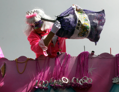 A rider on the Iris "Diamond" float pulls out a new bag of throws. (Robert Morris, UptownMessenger.com)