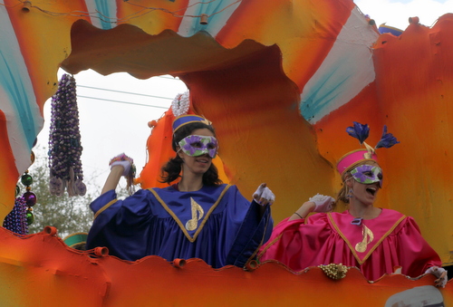 Riders on the Krewe of Iris "Rock of Ages" float throw to the Napoleon Avenue crowds. (Robert Morris, UptownMessenger.com)