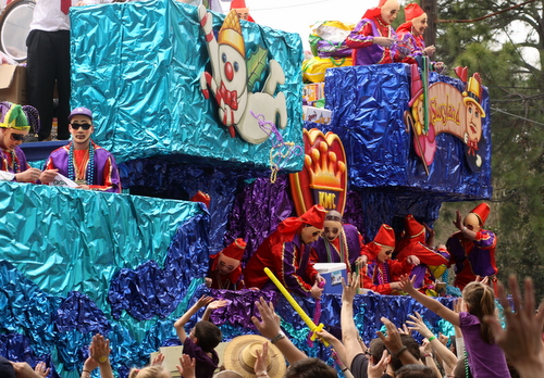 The Krewe of Mid-City "Tribute to City Park" float rolls down Magazine, as smoke from the train on the front wafts over the crowd. (Robert Morris, UptownMessenger.com)