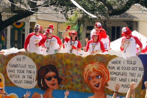 Riders toss beads from the Krewe of Tucks "Bat 'Er Up" float, featuring the double entendres throughout their "Sporting Life" theme. (Robert Morris, UptownMessenger.com)