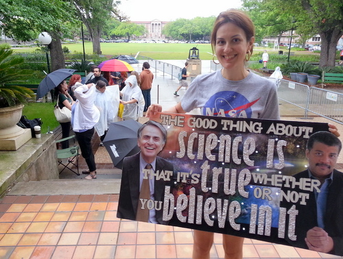 Alba Huddleston holds a sign she made honoring Neil deGrasse Tyson as she waits first in line Monday afternoon for his speaking appearance at Tulane later that night. (Robert Morris, UptownMessenger.com)