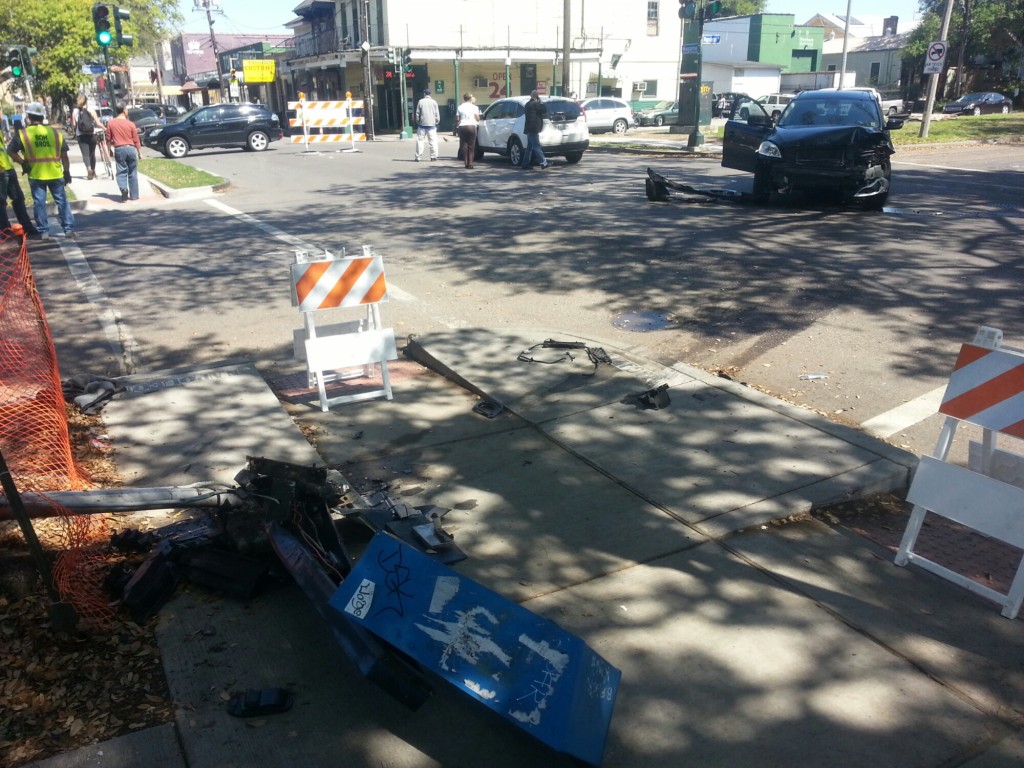 A public phone stand lays damaged after an April 10 crash at Magazine and Napoleon. It's still there. (UptownMessenger.com file photo)
