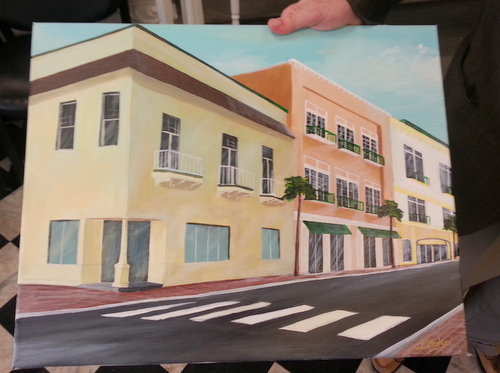 Arnold Kirschman holds a painting of his plan for the buildings in the 4500 block of Freret Street. (Robert Morris, UptownMessenger.com)