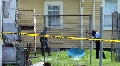 Police investigate a fatal shooting on Milan Street. (Robert Morris, UptownMessenger.com)