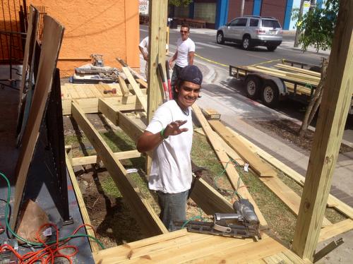 A volunteer works on a new wheelchair ramp at the Freret Neighborhood Center. (photo via the Freret Neighborhood Center on Facebook)