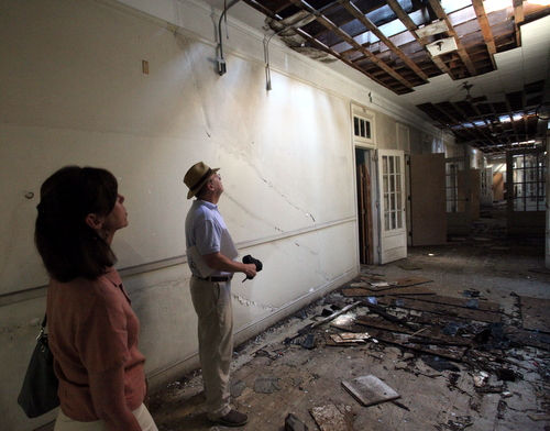 Barbara Griffin and John Wettermark of the International School of Louisiana examine roof damage on the third floor of the Priestley building. (Robert Morris, UptownMessenger.com)