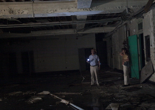 John Wettermark and Barbara Griffin stand near water pooling in the first floor of the Priestley building. (Robert Morris, UptownMessenger.com)