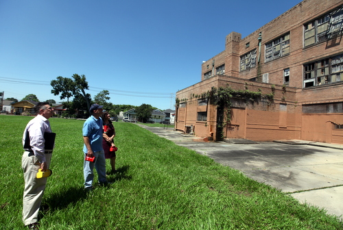 Keith Bartlett, Jim MacPhaille and Marina Schoen from Lycee Francais stand in the rear field at Priestley and examine the building's exterior. (Robert Morris, UptownMessenger.com)