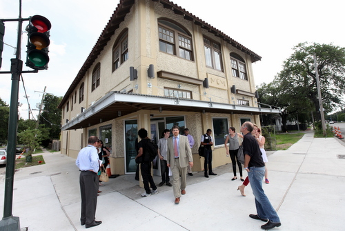 Will Bradshaw (center), president of Green Coast Enterprises, leads a tour of the old pharmacy building at Washington and Broad slated to be reborn this fall as South Broad Health Clinic. (Robert Morris, UptownMessenger.com)