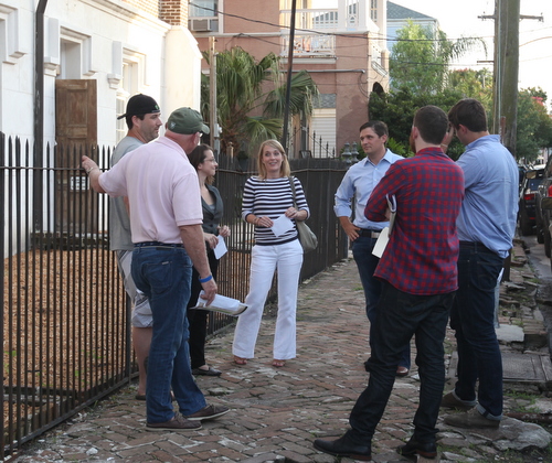 Jess Bourgeois of the proposed Lula restaurant and distillery and his wife (both center) speak with owners of Courtyard Brewery (left) and Barrel Proof bar (right) outside Felicity Church following Monday night's meeting of the Coliseum Square Association. (Robert Morris, UptownMessenger.com)