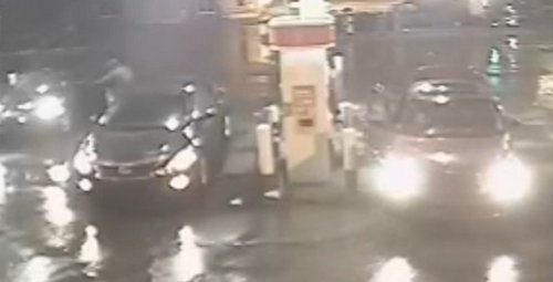 A still image from surveillance video released by the New Orleans Police Department shows the driver of the red PT Cruiser on the right getting into the Infiniti G35 on the far left before driving off in it.