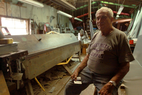Raymond Twickler Jr. holds an order pad in his metal shop on Cadiz Street. (Robert Morris, UptownMessenger.com)