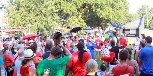 Kara Morgan's friends and supporters rally Saturday afternoon in Burke Park, where the neighborhood plans to build shade structures in her memory. (Robert Morris, UptownMessenger.com)
