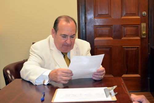 Judge Frank Marullo reads over the qualifying paperwork. (Photo by Danae Columbus for UptownMessenger.com)
