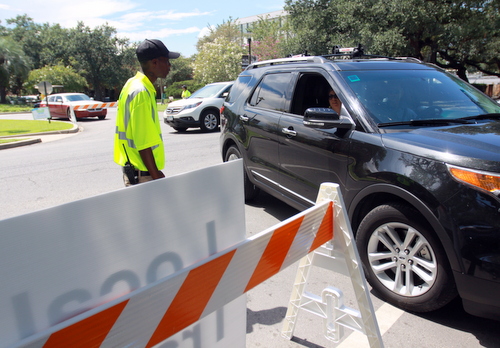 Jamal Warner of Standard Plus parking services checks a vehicle's pass to get onto Audubon Boulevard from Willow Street. (Robert Morris, UptownMessenger.comm)