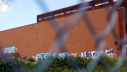 Graffiti tags line the back wall of the historic Booker T. Washington auditorium. (Robert Morris, UptownMessenger.com)