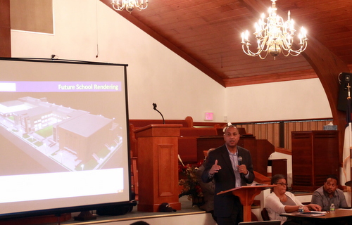 RSD Superintendent Patrick Dobard presents a rendering of the Booker T. Washington school during a meeting Tuesday night at Pure Light Baptist Church. (Robert Morris, UptownMessenger.com)