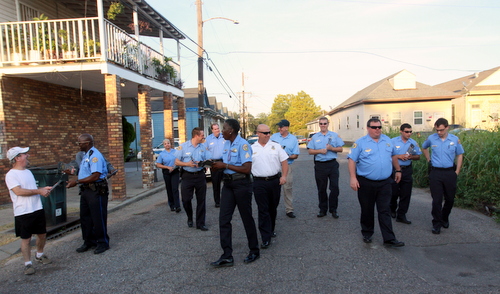 Commander Ronnie Stevens and members of the NOPD Sixth District walk on South Saratoga Street, steps between the scenes of two fatal shootings this year. (Robert Morris, UptownMessenger.com)