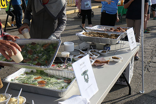 Food was provided for the runners and attendees including salad from Midway Pizza (left) and dirty rice and chicken from Freret Street Poboys and Donuts (right) (Zach Brien, UptownMessenger.com)