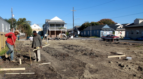 Workers from Cutting Edge Renovations prepare the vacant lot at Saratoga and Foucher on Wednesday, Nov. 20, for the construction of two new houses by Pentek Homes. (Robert Morris, UptownMessenger.com)