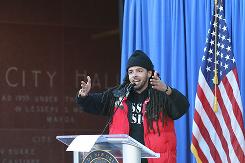 David Augustine Jr., the artist known as Dee-1, gives the keynote address during Monday's Martin Luther King celebration at New Orleans City Hall. (Zach Brien, UptownMessenger.com)