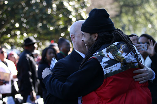 David Augustine Jr. embraces Mayor Mitch Landrieu at the Martin Luther King memorial on South Claiborne Avenue. (Zach Brien, UptownMessenger.com)