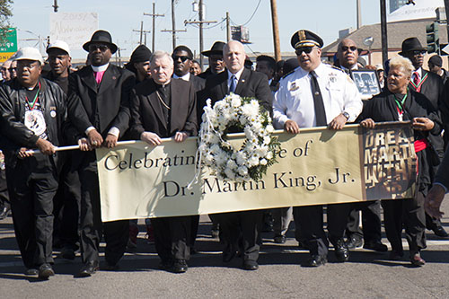 Mayor Mitch Landrieu, flanked by Archbishop Gregory Aymond on his left and NOPD Superintendent Michael Harrison on the right, march in commemoration of Martin Luther King Jr.'s legacy. (Zach Brien, UptownMessenger.com)